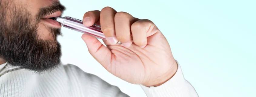 a man is vaping a disposable vape